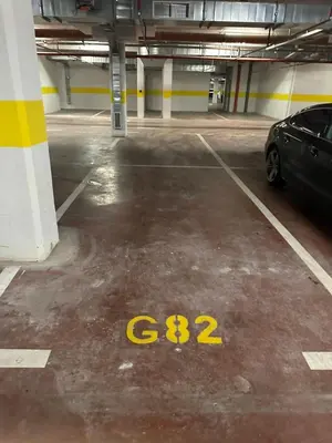a parking garage with a car parked in it at Cozy 1bd apartment Central point-GARAGE available 5e per day in Podgorica