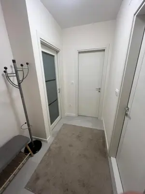 an empty room with two doors and a treadmill at Cozy 1bd apartment Central point-GARAGE available 5e per day in Podgorica