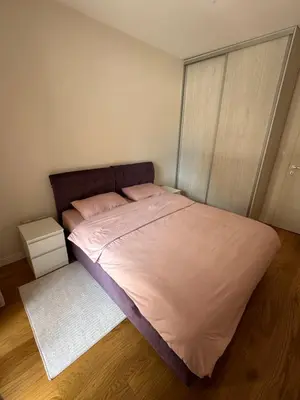 a bedroom with a large bed with pink sheets at Cozy 1bd apartment Central point-GARAGE available 5e per day in Podgorica