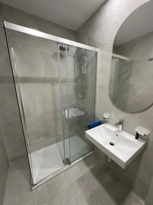 a bathroom with a shower and a sink at Cozy 1bd apartment Central point-GARAGE available 5e per day in Podgorica