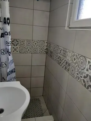a bathroom with a toilet and a sink and a window at Studio Kaća 2 in Cetinje