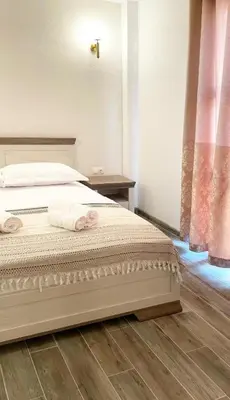 a bedroom with a bed with two towels on it at Guest House Bonaca in Ulcinj