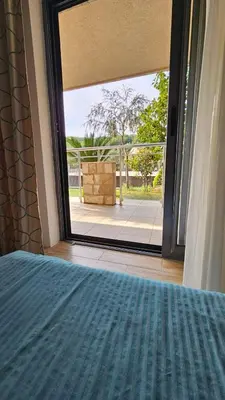 a bedroom with a bed and a large window at APARTMAN NIKA BUDVA-PRZNO in Budva