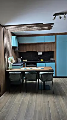 a kitchen with blue cabinets and a table and chairs at APARTMAN NIKA BUDVA-PRZNO in Budva