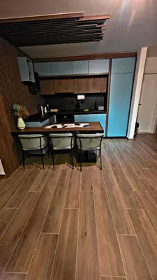 a kitchen with a table and chairs in a room at APARTMAN NIKA BUDVA-PRZNO in Budva