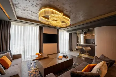 a living room with a couch and a table at Merit Starlit Hotel & Residences in Budva