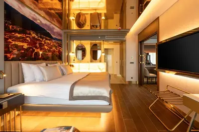 a bedroom with a large bed and a flat screen tv at Merit Starlit Hotel & Residences in Budva