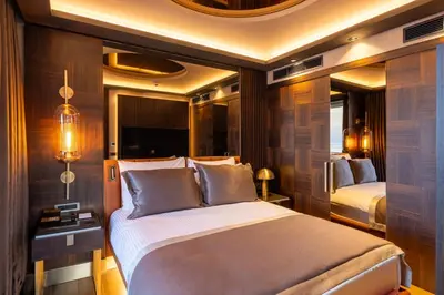 a bedroom with a bed and two beds in a room at Merit Starlit Hotel & Residences in Budva