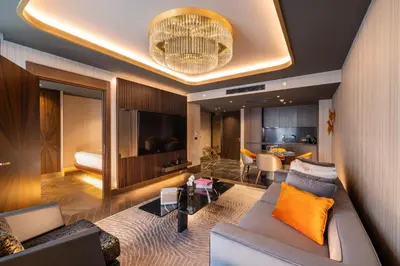 a living room with a couch and a television at Merit Starlit Hotel & Residences in Budva