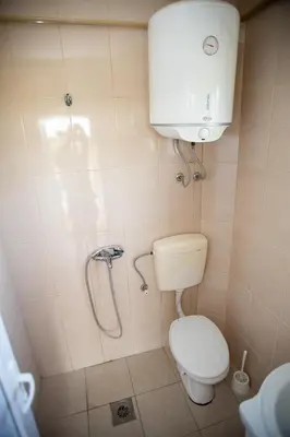 a small bathroom with a toilet and a shower at Villa Elezi in Ulcinj