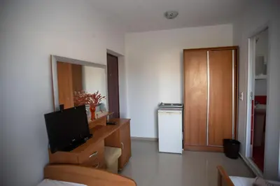 a living room with a television and a kitchen at Villa Elezi in Ulcinj