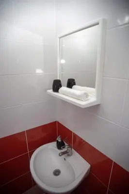 a bathroom with a sink and a mirror at Villa Elezi in Ulcinj