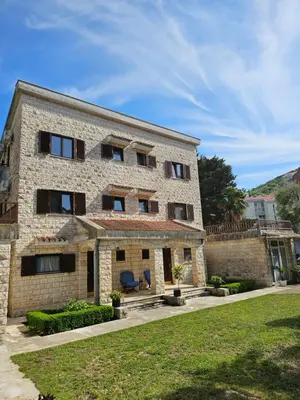 a stone building with a yard in front of it at Bravo Plus in Budva