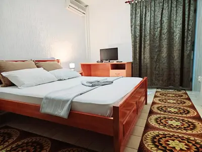 a bedroom with a large bed and a television at Bravo Plus in Budva