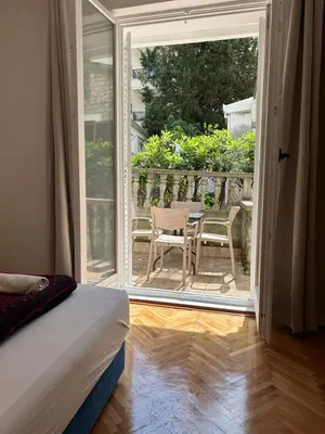 a bedroom with a door open to a patio at Apartments and Room MV in Petrovac na Moru