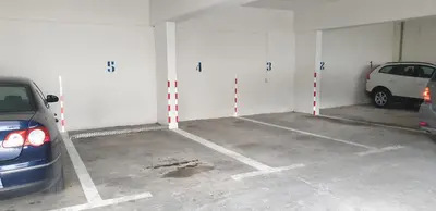 a parking garage with two cars parked in it at Apartment Hill with Free Garage Spot in Kotor
