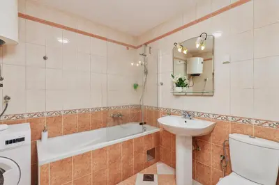 a bathroom with a sink and a toilet and a tub at Apartment Hill with Free Garage Spot in Kotor