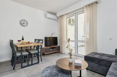 a living room with a couch and a table at Apartment Hill with Free Garage Spot in Kotor