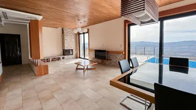 a living room with a view of a pool at Villa Tivat Bay View in Kotor