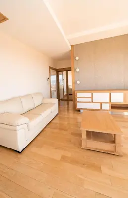 a living room with a white couch and a wooden table at Villa Tivat Bay View in Kotor