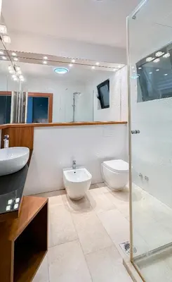 a bathroom with two sinks and a shower at Villa Tivat Bay View in Kotor