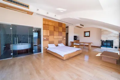 a bedroom with a bed and a tub and a table at Villa Tivat Bay View in Kotor