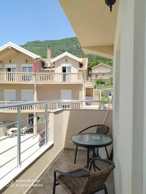 a patio with a table and chairs on a balcony at Rada in Kavač
