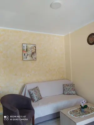 a living room with a couch and a table at Rada in Kavač