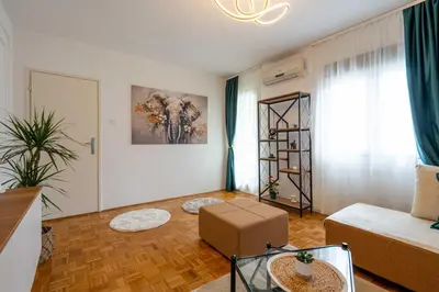 a living room with a couch and a table at Apartment UR in Bar