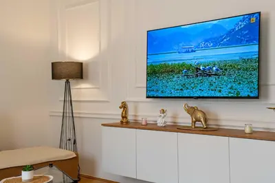 a living room with a flat screen tv on a wall at Apartment UR in Bar