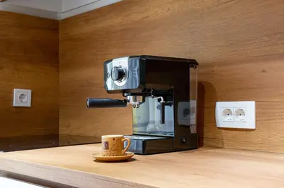 a coffee maker sitting on a counter with a coffee cup at Apartment UR in Bar