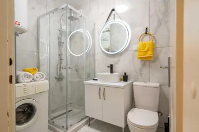 a bathroom with a shower and a toilet and a sink at Apartment UR in Bar