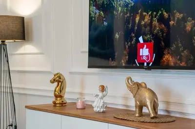 a table with two gold figurines and a lamp at Apartment UR in Bar