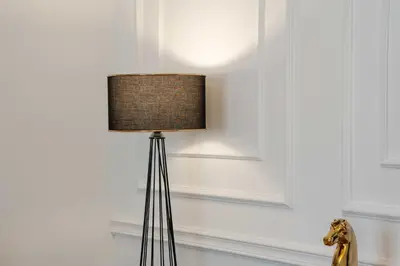 a black floor lamp with a brown shade on a wall at Apartment UR in Bar