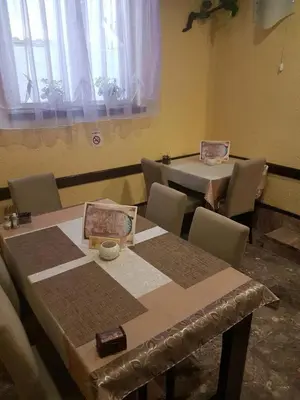 a dining room with two tables and chairs in a room at Apartments Bonus in Budva
