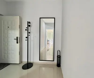 a mirror on a wall in a white room at Danver Apartment in Bar