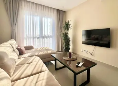 a living room with a couch and a table at Danver Apartment in Bar