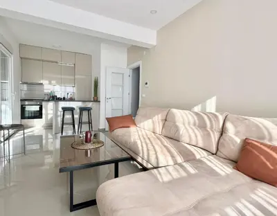 a living room with a couch and a table at Danver Apartment in Bar