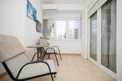 a living room with a chair and a table at Apartman Klara Podgorica in Podgorica
