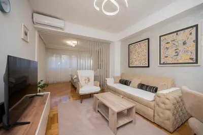 a living room with a couch and a table at Apartman Klara Podgorica in Podgorica
