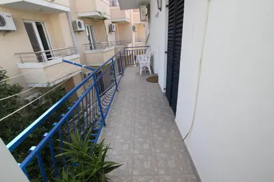 a balcony of a building with a table and a chair at Apartments Vila Nikolić Rafailovići in Rafailovici