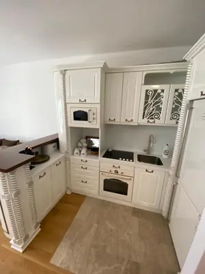 a kitchen with white cabinets and a sink at Lux Apartment Meecoon Rafailovići in Rafailovici