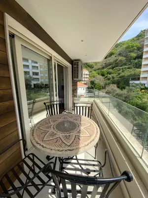 a table and chairs on a balcony with a view at Lux Apartment Meecoon Rafailovići in Rafailovici