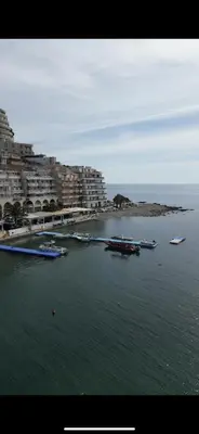 a group of boats in a body of water with buildings at Lux Apartment Meecoon Rafailovići in Rafailovici