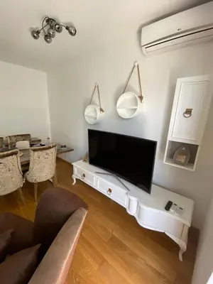 a living room with a flat screen tv on a wall at Lux Apartment Meecoon Rafailovići in Rafailovici