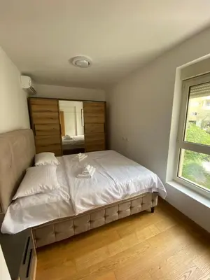 a bedroom with a large bed with a window at Lux Apartment Meecoon Rafailovići in Rafailovici