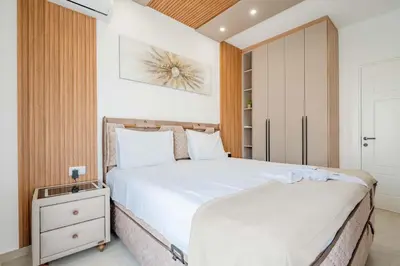 a bedroom with two beds and a closet at Vienna Luxury Apartments in Dobra Voda