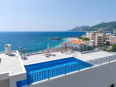 a view of the ocean from a building with a swimming pool at Vienna Luxury Apartments in Dobra Voda