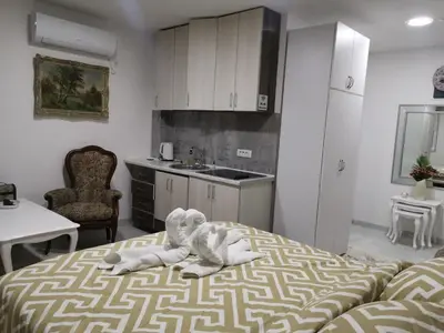 a room with a bed with an elephant on it at In Apartments AirPort in Mitrovići