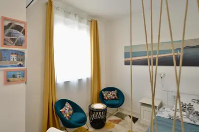 two blue chairs in a room with a window at TriA Studio in Bar